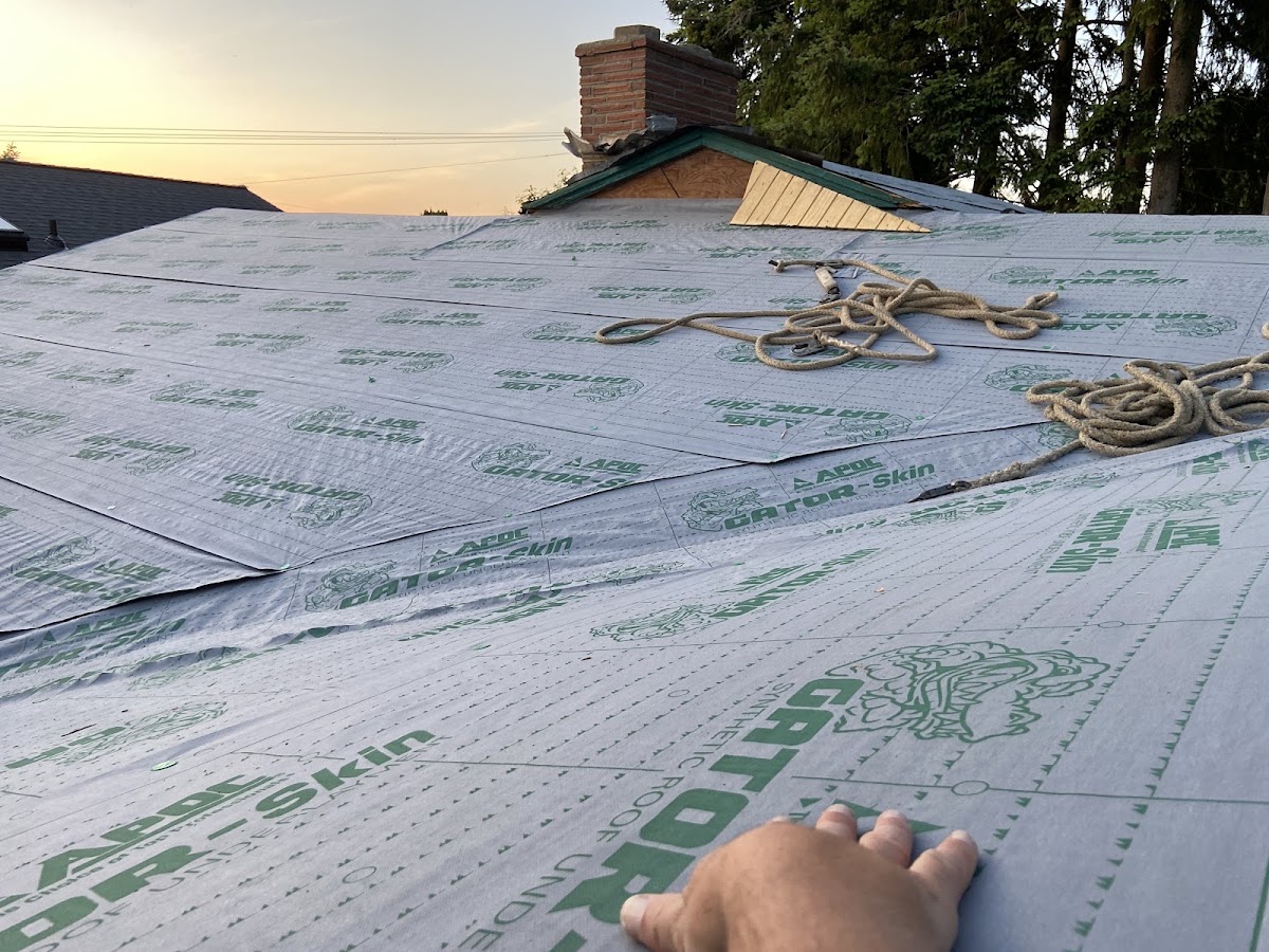 Synthetic roof underlayment being installed close up